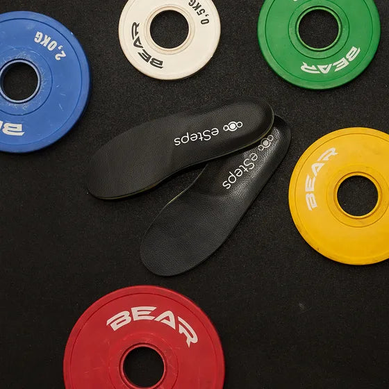 Open the gallery: the eSteps insoles among coloured weight plates.