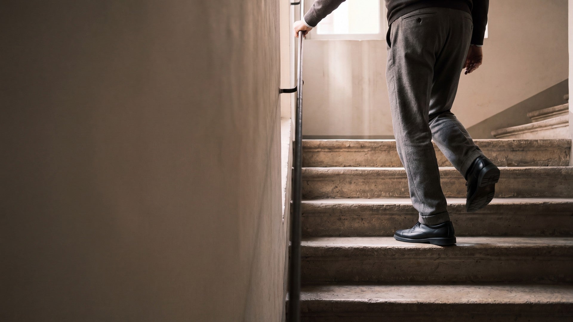 Someone in trainers climbing a flight of outdoor steps